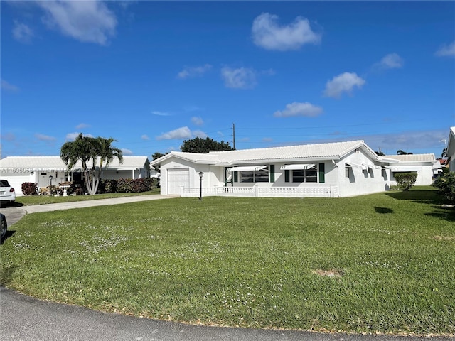 view of front of property with a front lawn and a garage