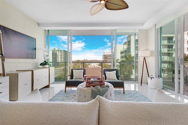 interior space with expansive windows and ceiling fan