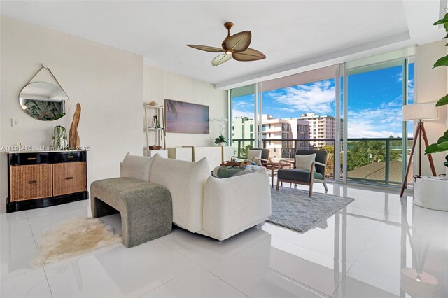 living room with ceiling fan, light tile patterned flooring, and floor to ceiling windows