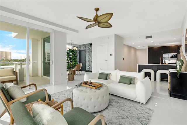 living room featuring ceiling fan, light tile patterned floors, and sink