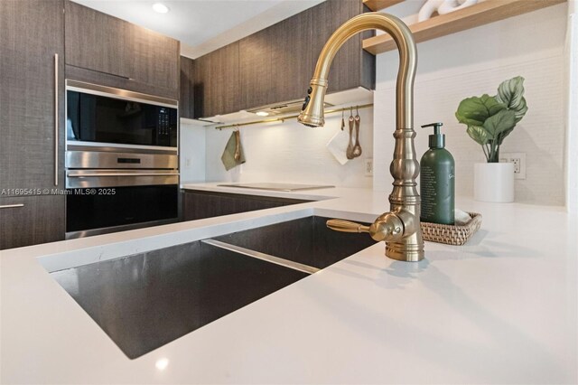 interior details featuring dark brown cabinetry and appliances with stainless steel finishes