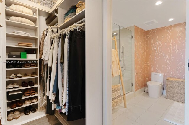 walk in closet with tile patterned floors