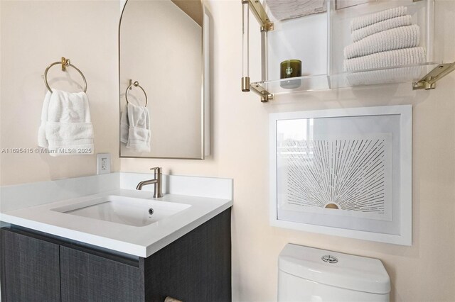 bathroom featuring vanity and toilet