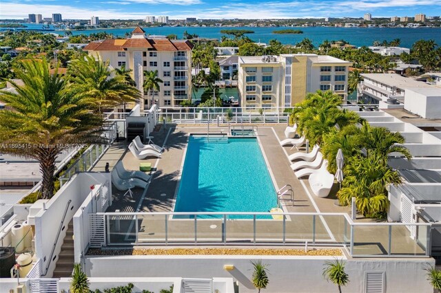 view of swimming pool featuring a water view