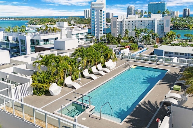 view of pool with a patio and a water view