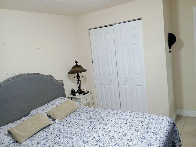 tiled bedroom featuring a closet