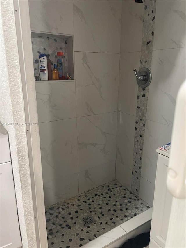 bathroom with a tile shower