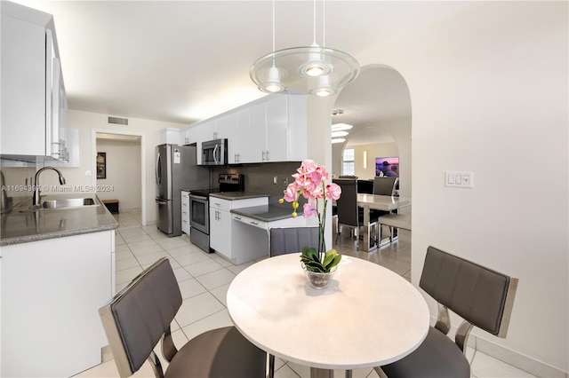 dining room with sink and light tile patterned floors