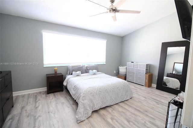 bedroom with light wood-type flooring, multiple windows, and ceiling fan