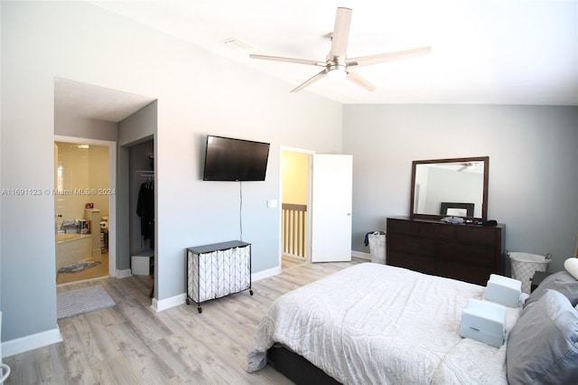 bedroom featuring connected bathroom, ceiling fan, lofted ceiling, a closet, and light wood-type flooring