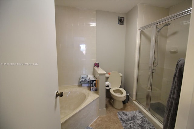 bathroom with tile patterned floors, independent shower and bath, and toilet