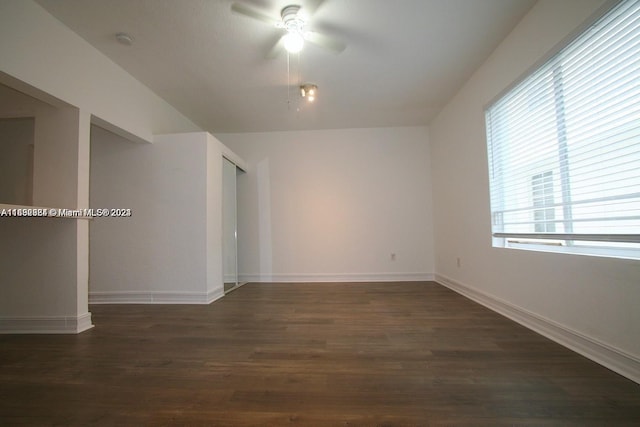 spare room with dark hardwood / wood-style floors and ceiling fan