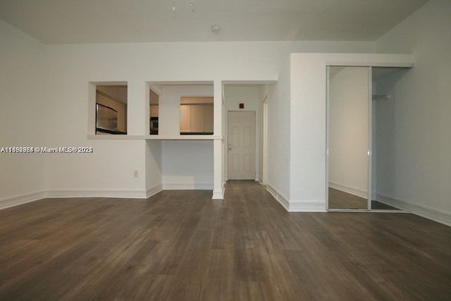 spare room with dark wood-type flooring