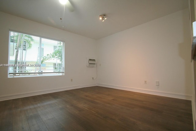 spare room featuring ceiling fan and dark hardwood / wood-style floors