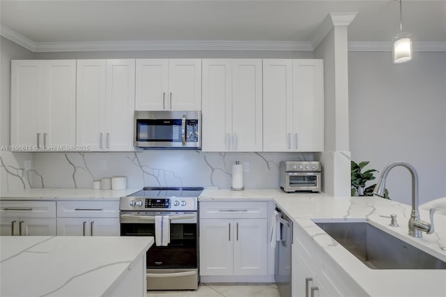 kitchen featuring pendant lighting, sink, white cabinetry, and stainless steel appliances