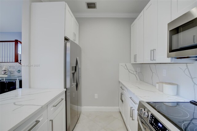 kitchen with sink, dishwasher, white cabinetry, hanging light fixtures, and light stone counters