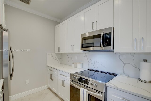 hall featuring crown molding and light tile patterned floors