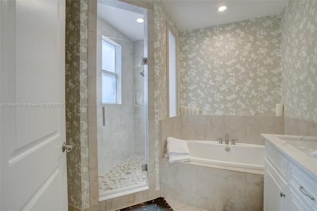 bathroom featuring tile patterned flooring, vanity, and shower with separate bathtub