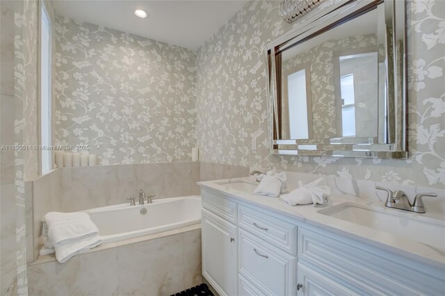 bathroom with tile patterned flooring, vanity, and a relaxing tiled tub