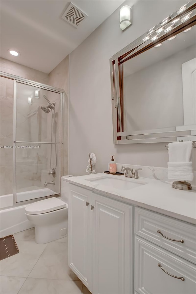 full bathroom featuring toilet, vanity, and bath / shower combo with glass door