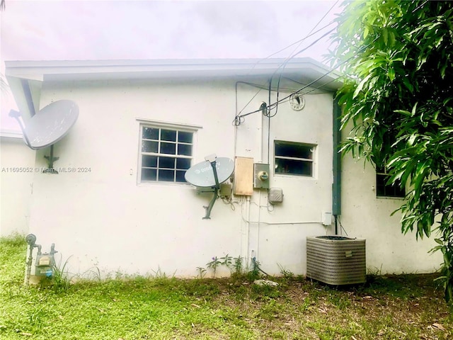 view of side of property with central air condition unit