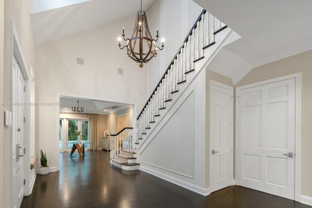 staircase with wood-type flooring, high vaulted ceiling, an inviting chandelier, and crown molding