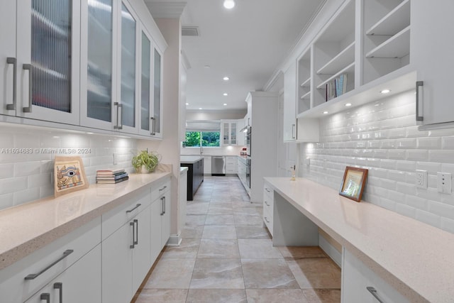 kitchen with dishwasher, light stone counters, white cabinetry, and tasteful backsplash