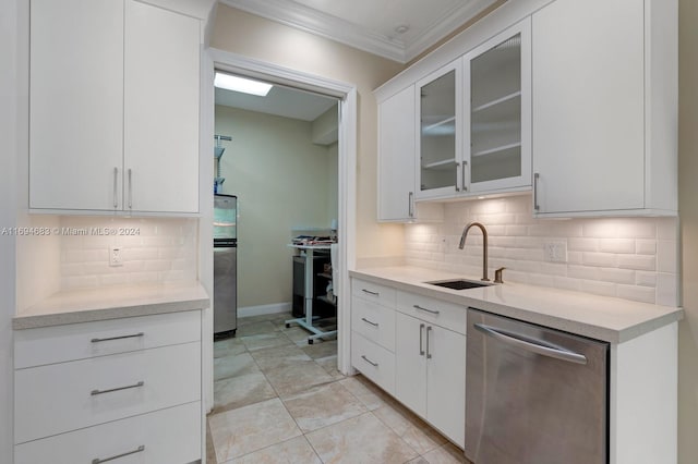 kitchen with backsplash, white cabinets, sink, ornamental molding, and stainless steel appliances