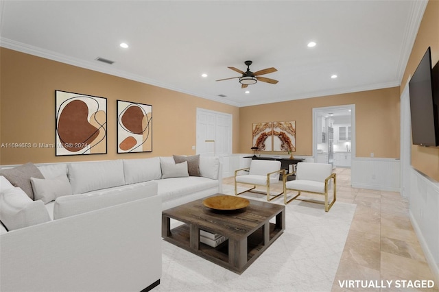 living room featuring ceiling fan and ornamental molding