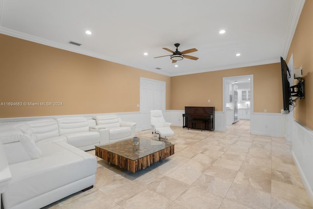 living room featuring ceiling fan and crown molding