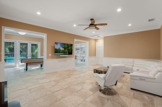 living room featuring ceiling fan, ornamental molding, and billiards