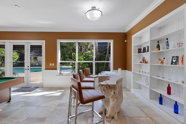 dining space featuring built in features, crown molding, pool table, and french doors