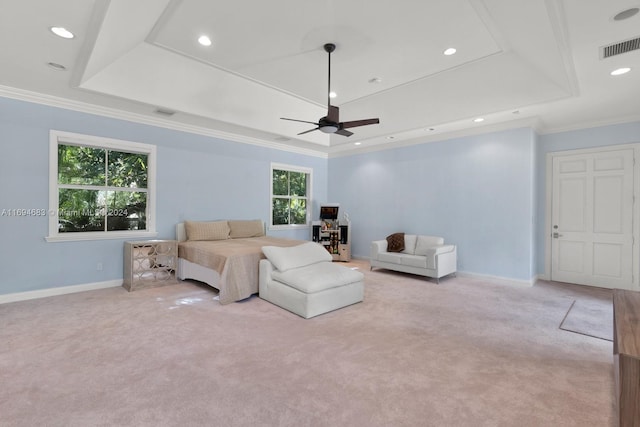 carpeted bedroom featuring multiple windows, a raised ceiling, and ceiling fan