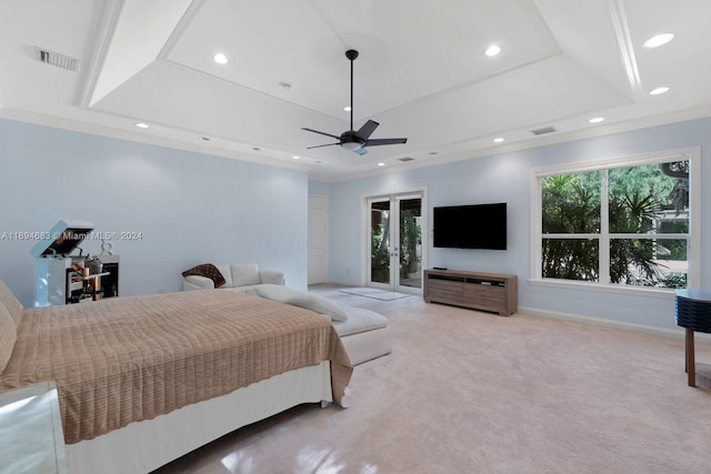 carpeted bedroom featuring ceiling fan, access to exterior, ornamental molding, and a tray ceiling