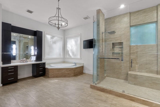 bathroom featuring a chandelier, vanity, and independent shower and bath