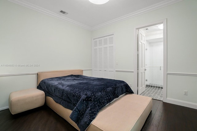 bedroom with dark hardwood / wood-style floors, crown molding, and ensuite bath