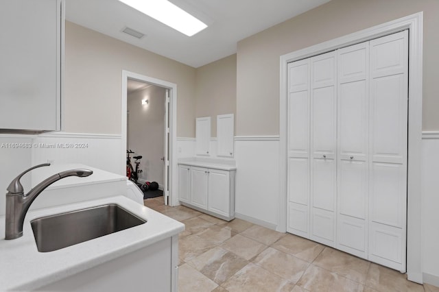 kitchen with white cabinetry and sink