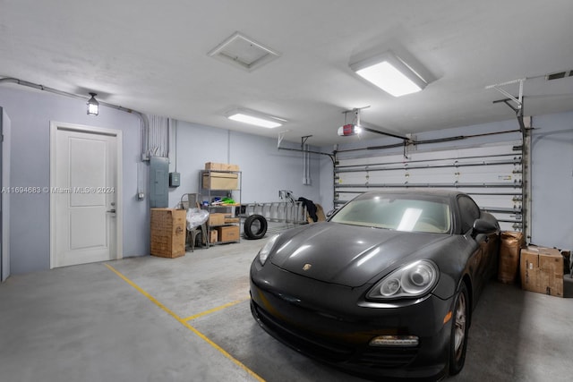 garage featuring electric panel and a garage door opener