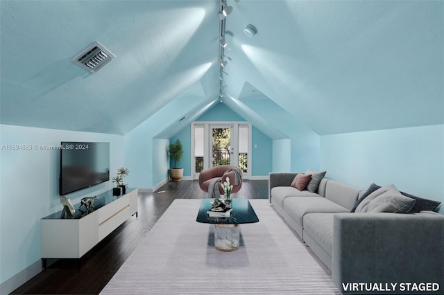 living room featuring track lighting, dark hardwood / wood-style floors, and vaulted ceiling