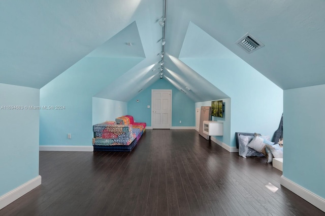 bedroom with dark hardwood / wood-style floors and lofted ceiling