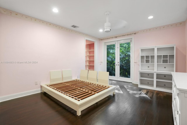 bedroom featuring ceiling fan, dark wood-type flooring, access to outside, a walk in closet, and a closet