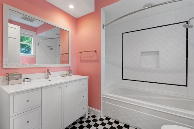 bathroom featuring vanity and tiled shower / bath