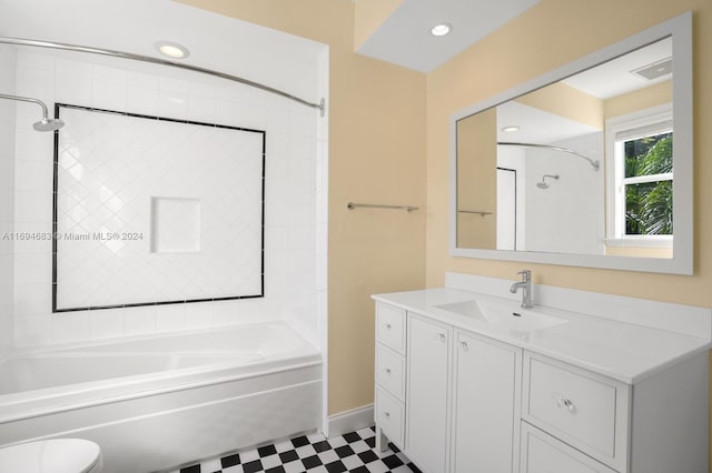 full bathroom with vanity, tiled shower / bath combo, and toilet