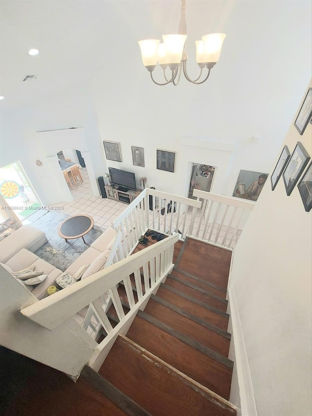 staircase featuring a notable chandelier