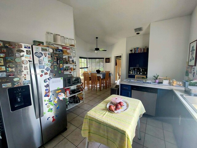 kitchen featuring ceiling fan, appliances with stainless steel finishes, light tile patterned flooring, and blue cabinets