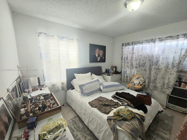 tiled bedroom with a textured ceiling