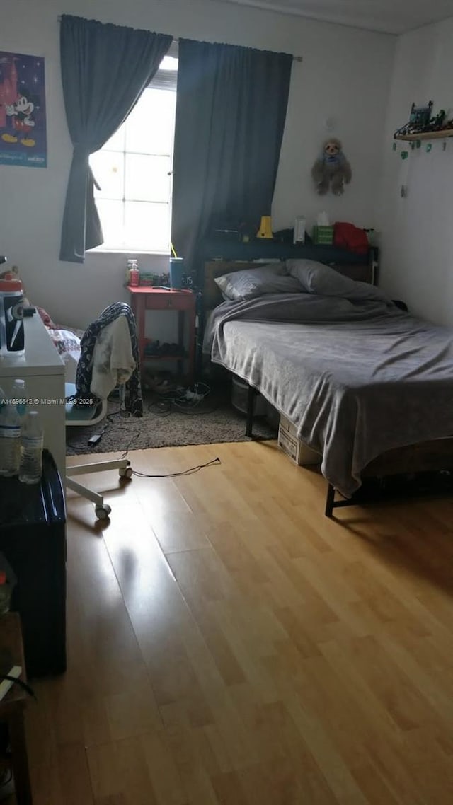 bedroom with wood-type flooring