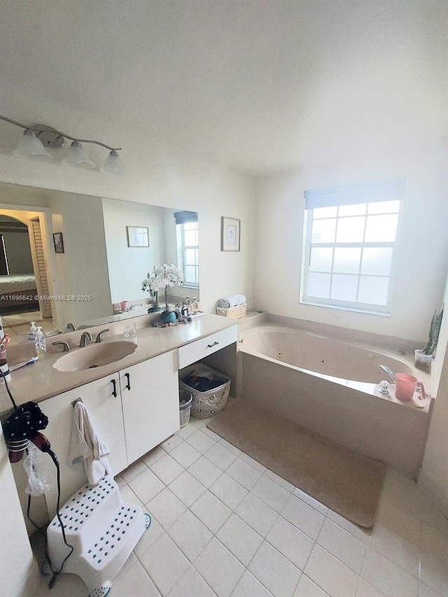 bathroom with vanity, tile patterned flooring, and a washtub