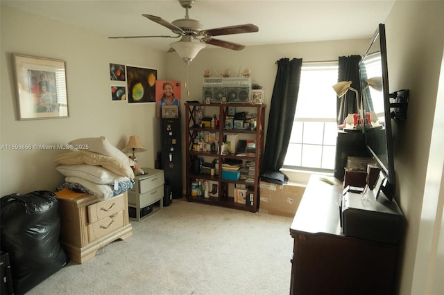 home office featuring light carpet and a ceiling fan