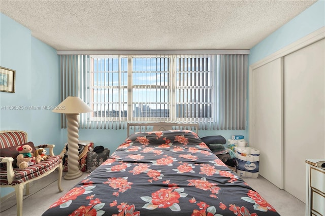 bedroom with a textured ceiling, a closet, and carpet